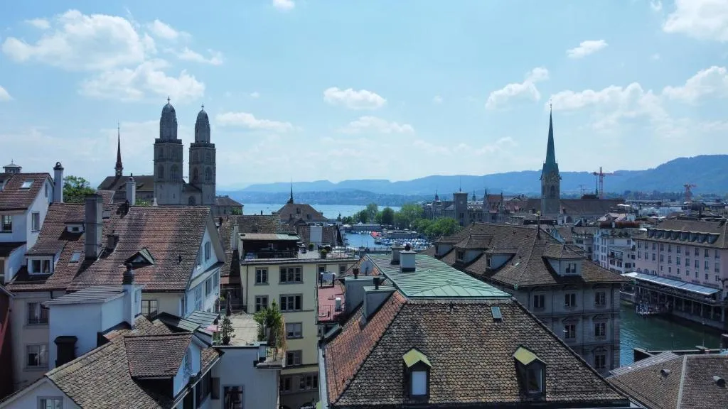 View over the rooftops of Zurich's Old Town with Grossmünster and Lake Zurich