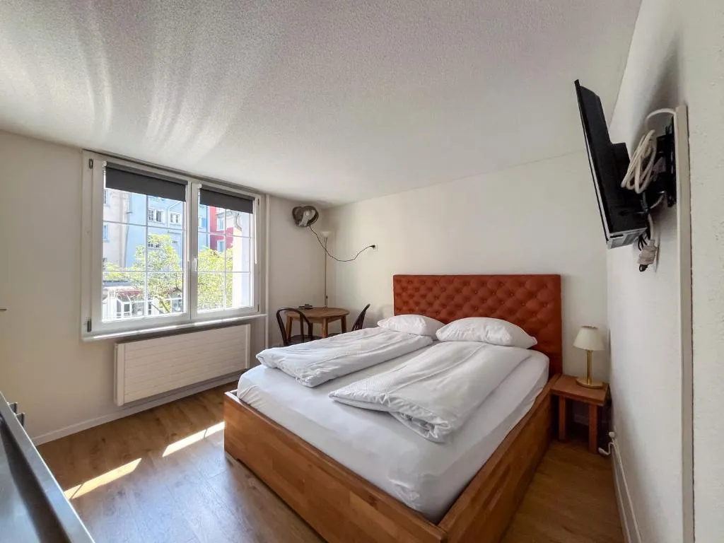 Double room in morning light overlooking an Old Town lane